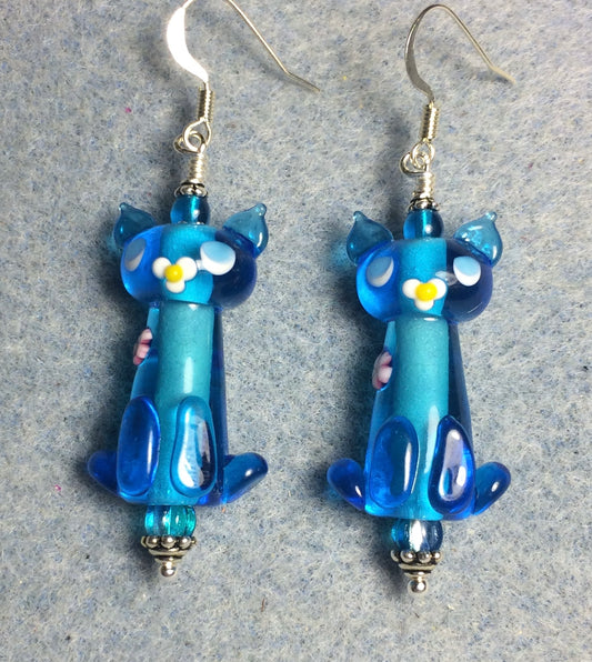 Translucent turquoise lamp work cat bead earrings adorned with turquoise Czech glass beads.