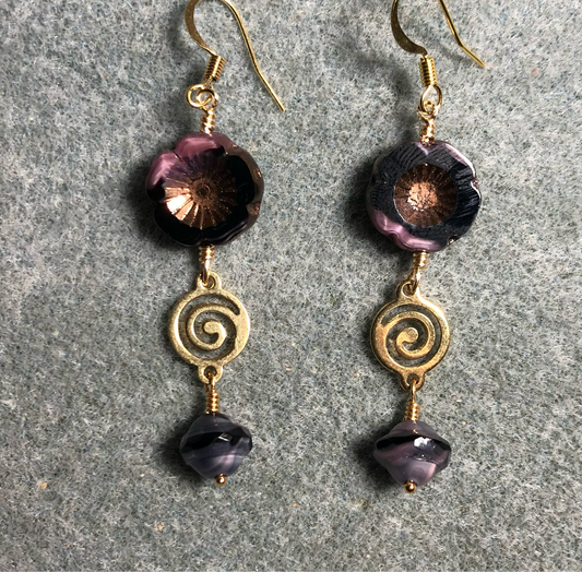 Pink and black Czech glass pansy bead earrings adorned with gold swirly connectors and pink and black Czech glass Saturn beads.