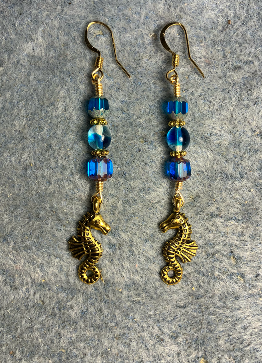 Gold seahorse charm earrings adorned with turquoise Czech glass beads