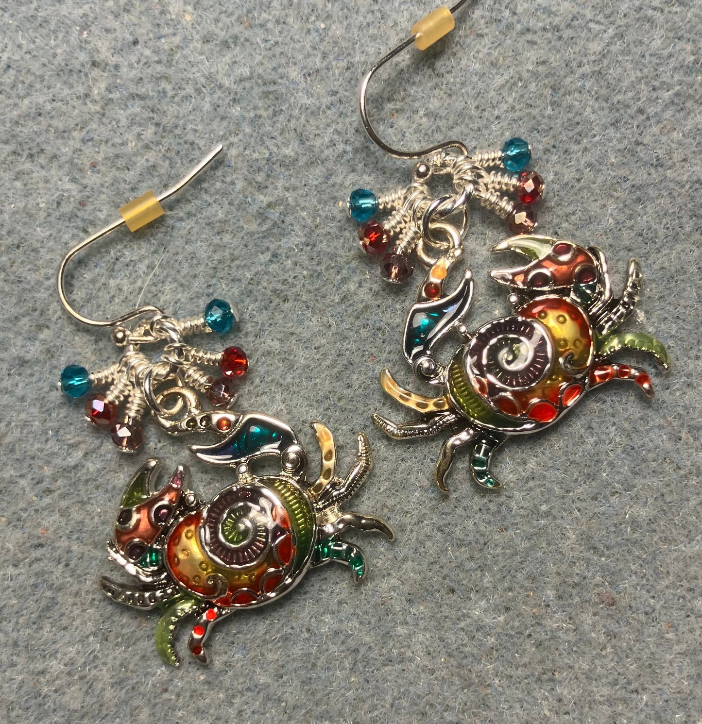 Silver and multicolored enamel crab charm earrings adorned with tiny dangling violet, red, and turquoise Chinese crystal beads.