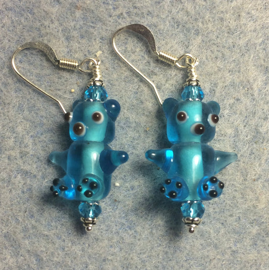 Small translucent turquoise lamp work teddy bear bead earrings adorned with turquoise Chinese crystal beads.