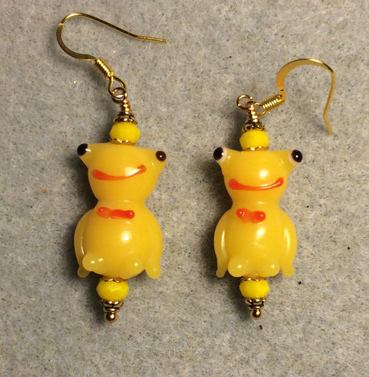 Golden yellow lamp work silly frog bead earrings adorned with yellow Chinese crystal beads.