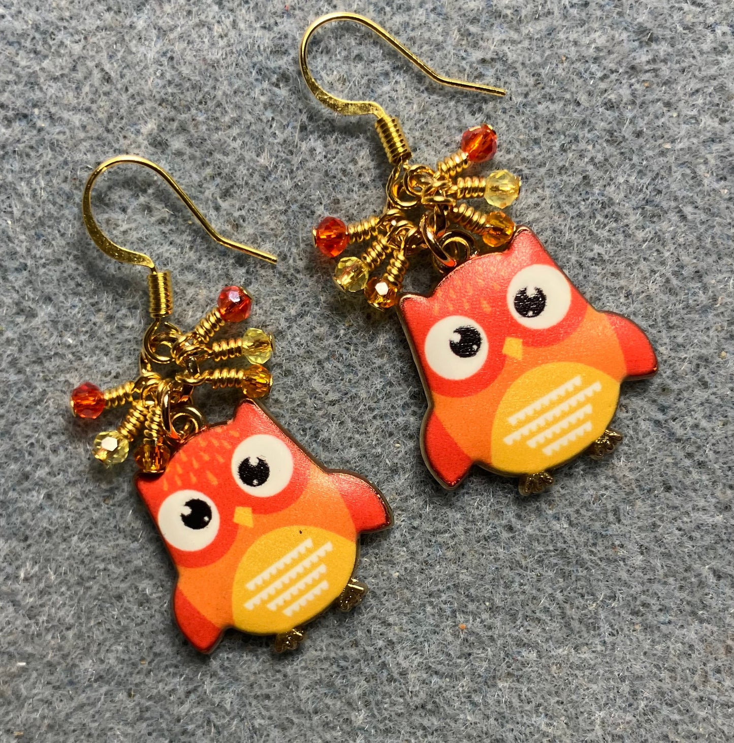 Orange and yellow enamel owl charm earrings adorned with tiny dangling orange and yellow Chinese crystal beads.