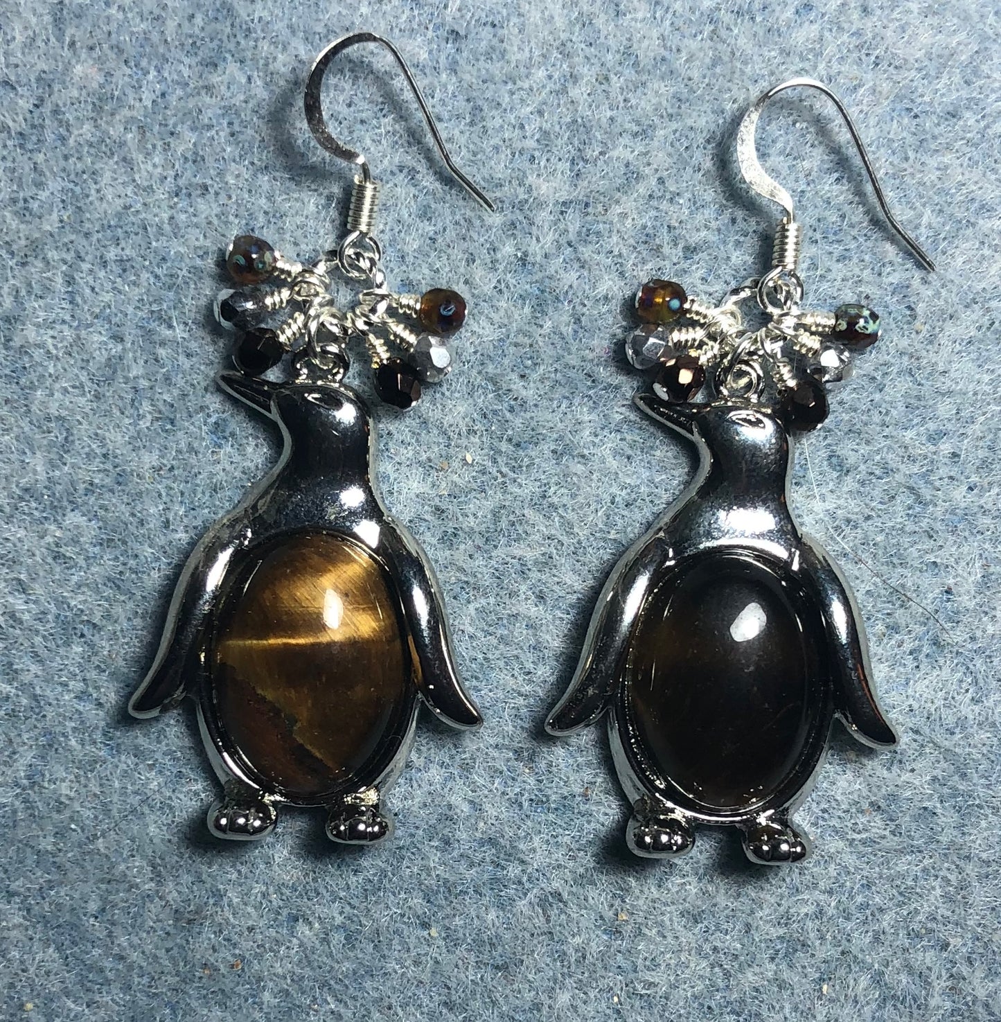 Large silver and tigereye gemstone penguin charm earrings adorned with small dangling brown and silver Czech glass beads.