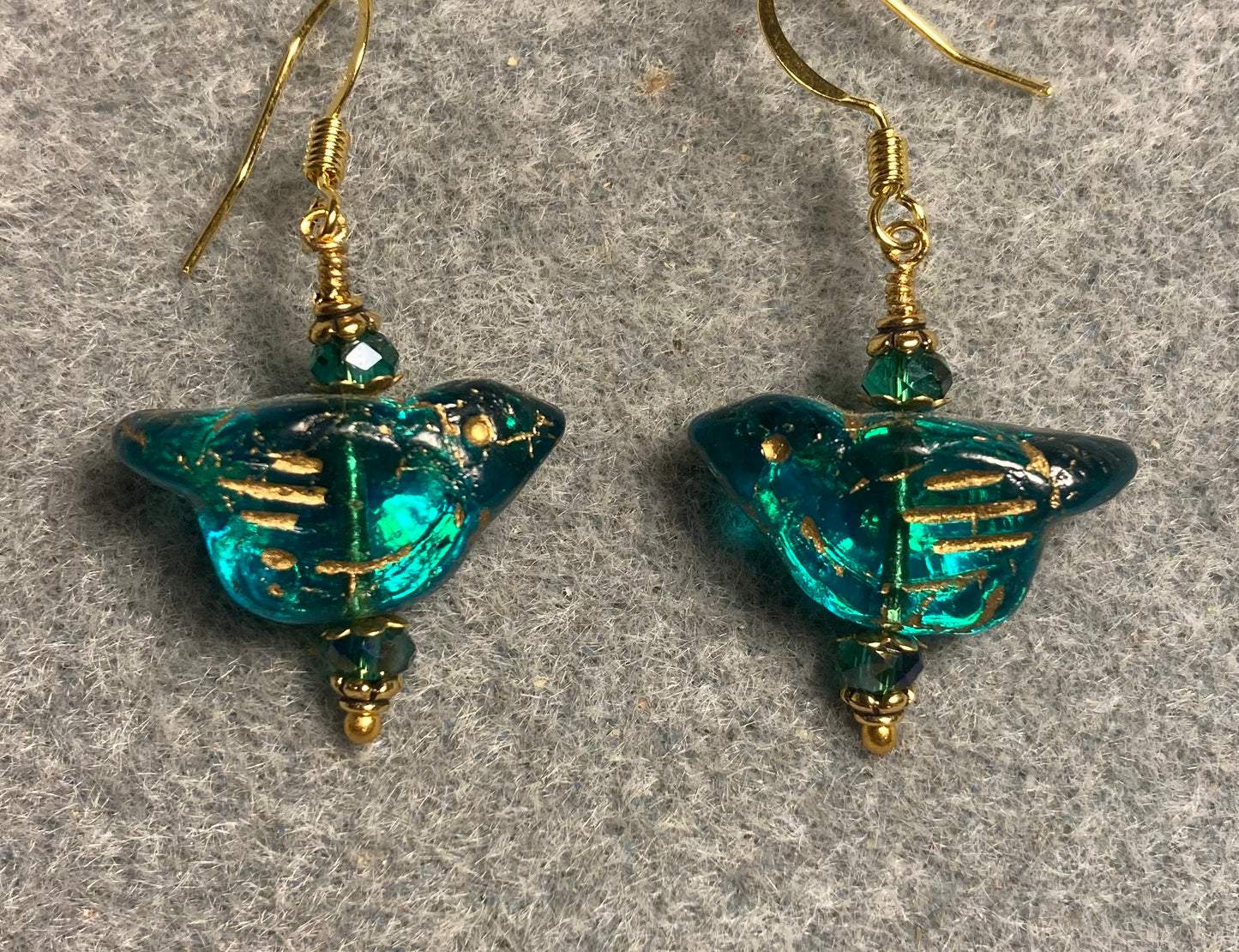Teal (with gold wash) Czech glass bird bead earrings adorned with teal Chinese crystal beads.