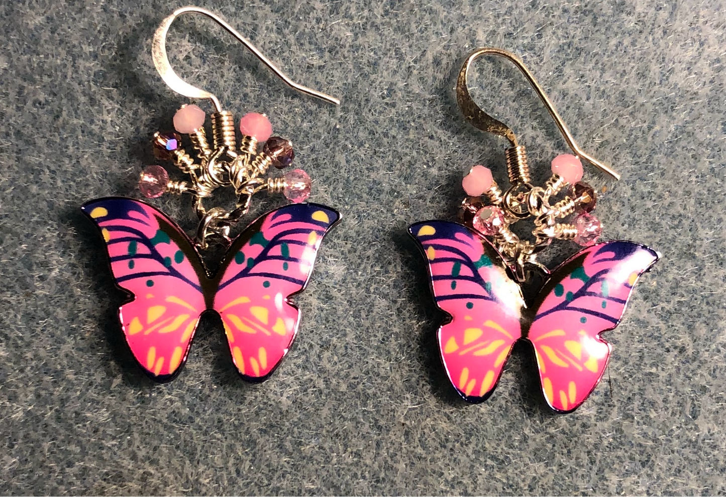 Pink and violet enamel butterfly charm earrings adorned with tiny dangling pink and violet Chinese crystal beads.