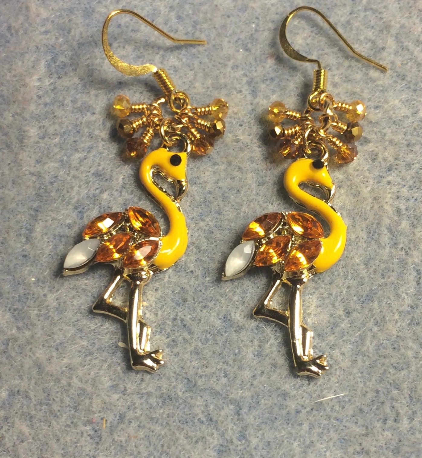 Amber enamel and rhinestone flamingo charm earrings adorned with tiny dangling amber and gold Chinese crystal beads.