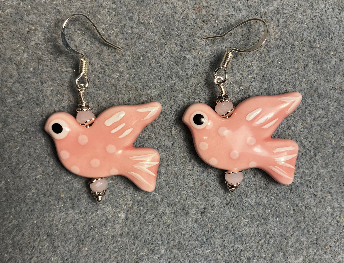 Large pink and white ceramic spotted dove bead earrings adorned with pink Chinese crystal beads.