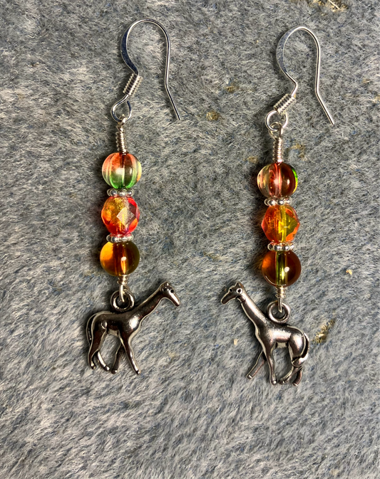 Silver giraffe charm earrings adorned with orange green Czech glass beads