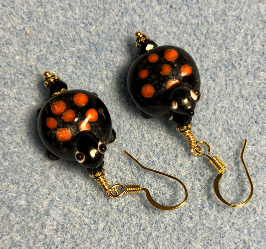 Black with red spots lamp work turtle bead earrings adorned with black Chinese crystal beads.