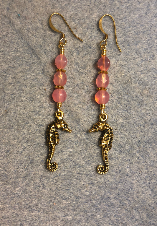 Gold seahorse charm earrings adorned with milky pink Czech glass beads