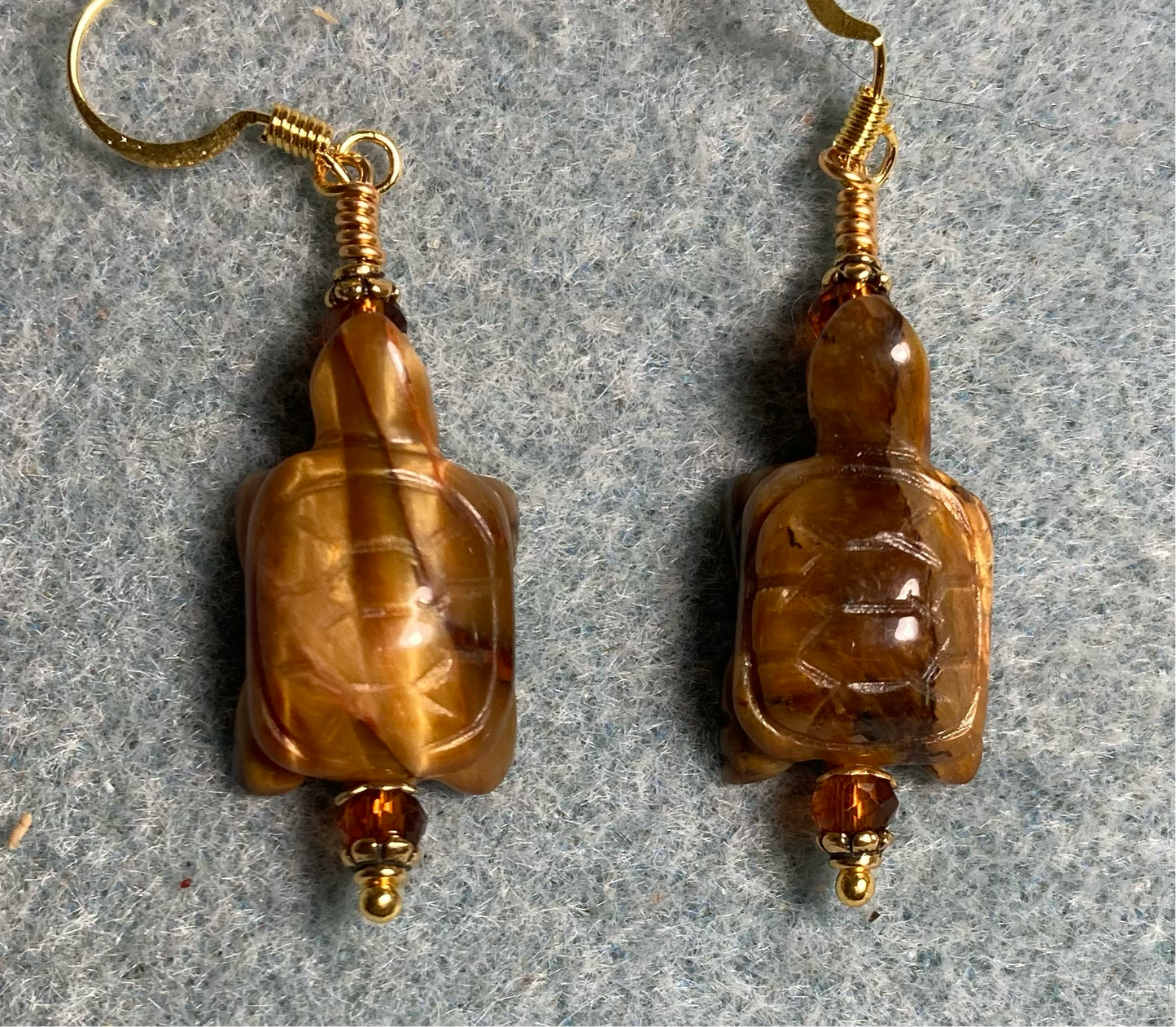 Brown tigereye gemstone turtle bead earrings adorned with amber Chinese crystal beads.