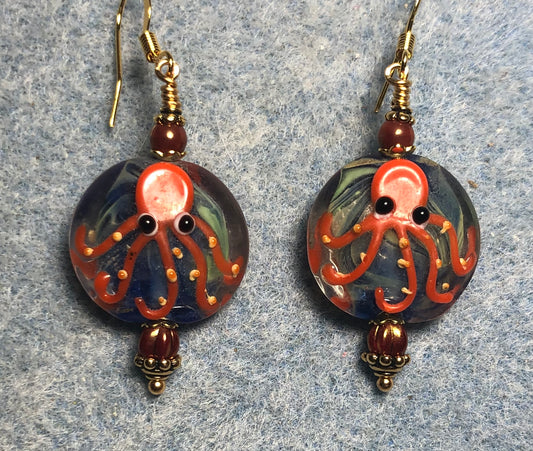 Blue and orange lamp work octopus bead earrings adorned with orange Czech glass beads.