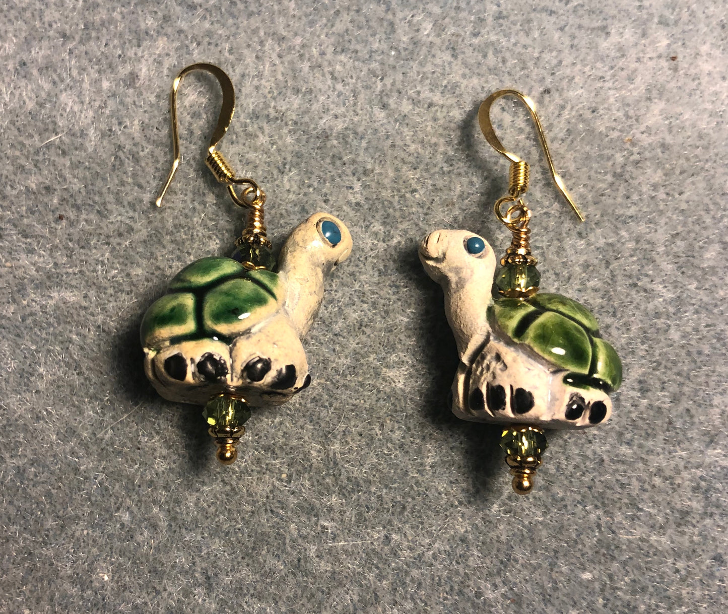 Medium green and tan ceramic turtle bead earrings adorned with sparkly green Chinese crystal beads.