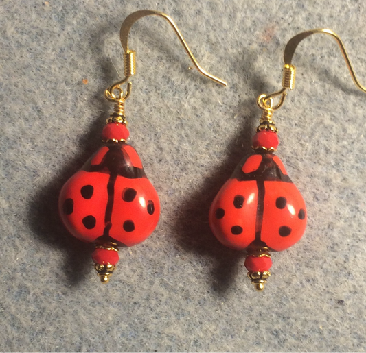 Red and black ceramic ladybug bead earrings adorned with red Chinese crystal beads.