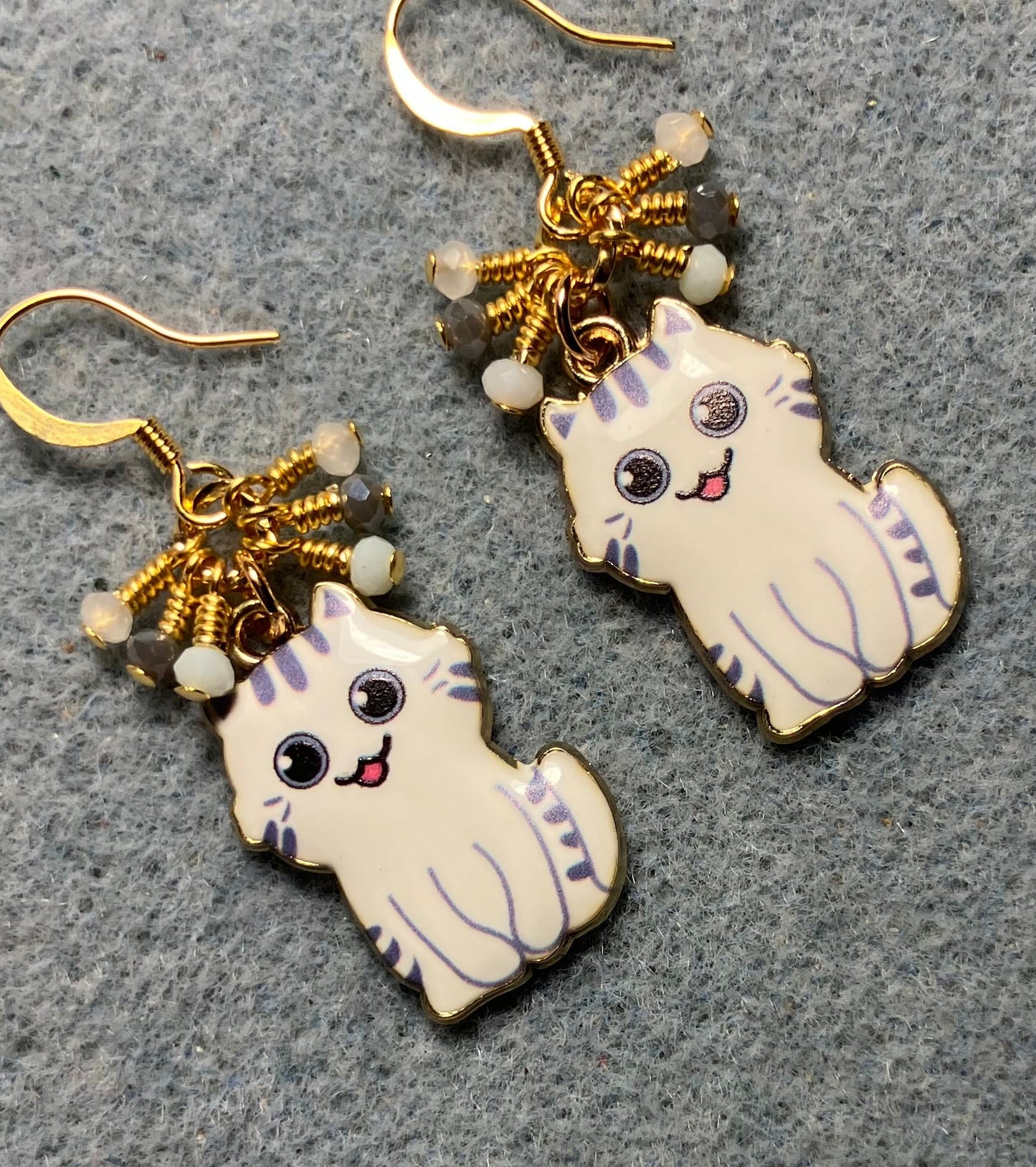 White and gray enamel cat charm earrings adorned with tiny dangling white and gray Chinese crystal beads.