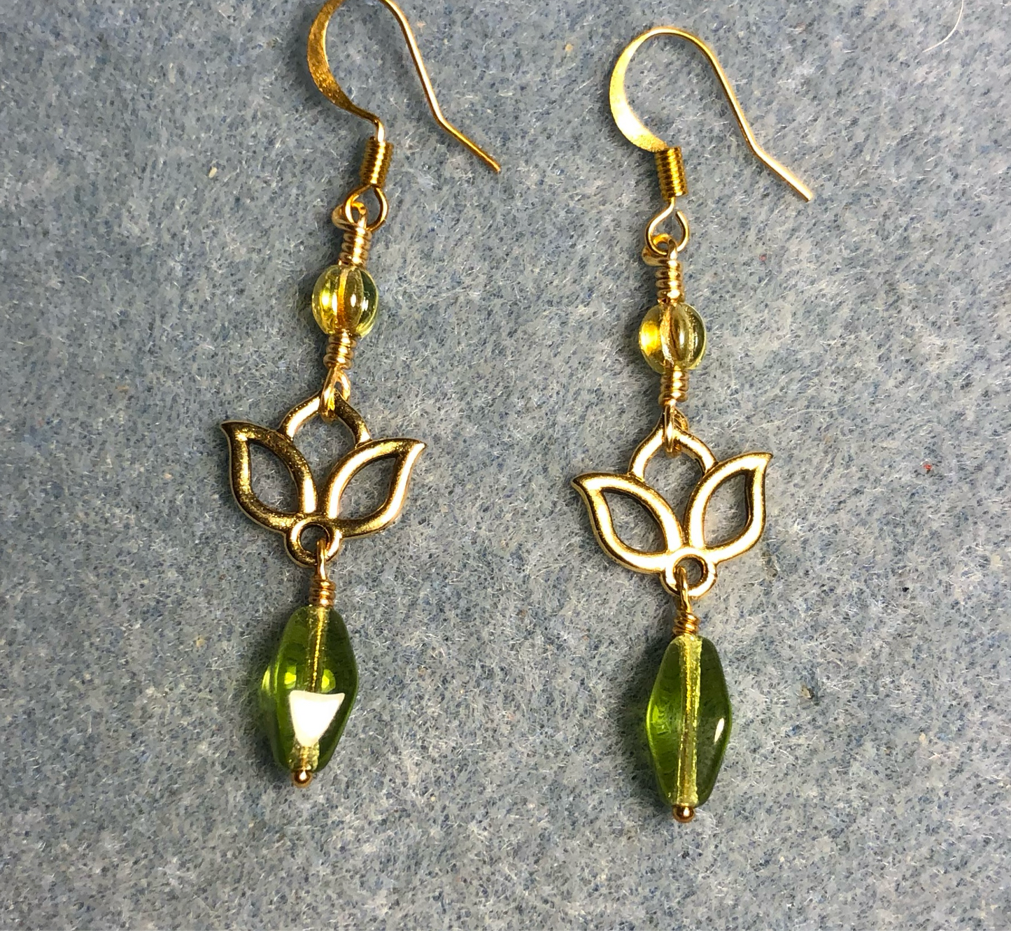 Small gold lotus flower connector charm earrings adorned with olive green Czech glass drop beads and olive green Czech glass melon beads.