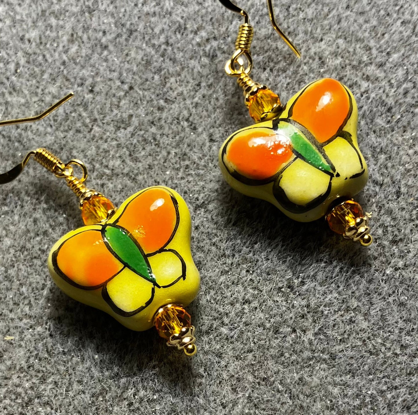 Tangerine and yellow ceramic butterfly bead earrings adorned with tangerine Chinese crystal beads.