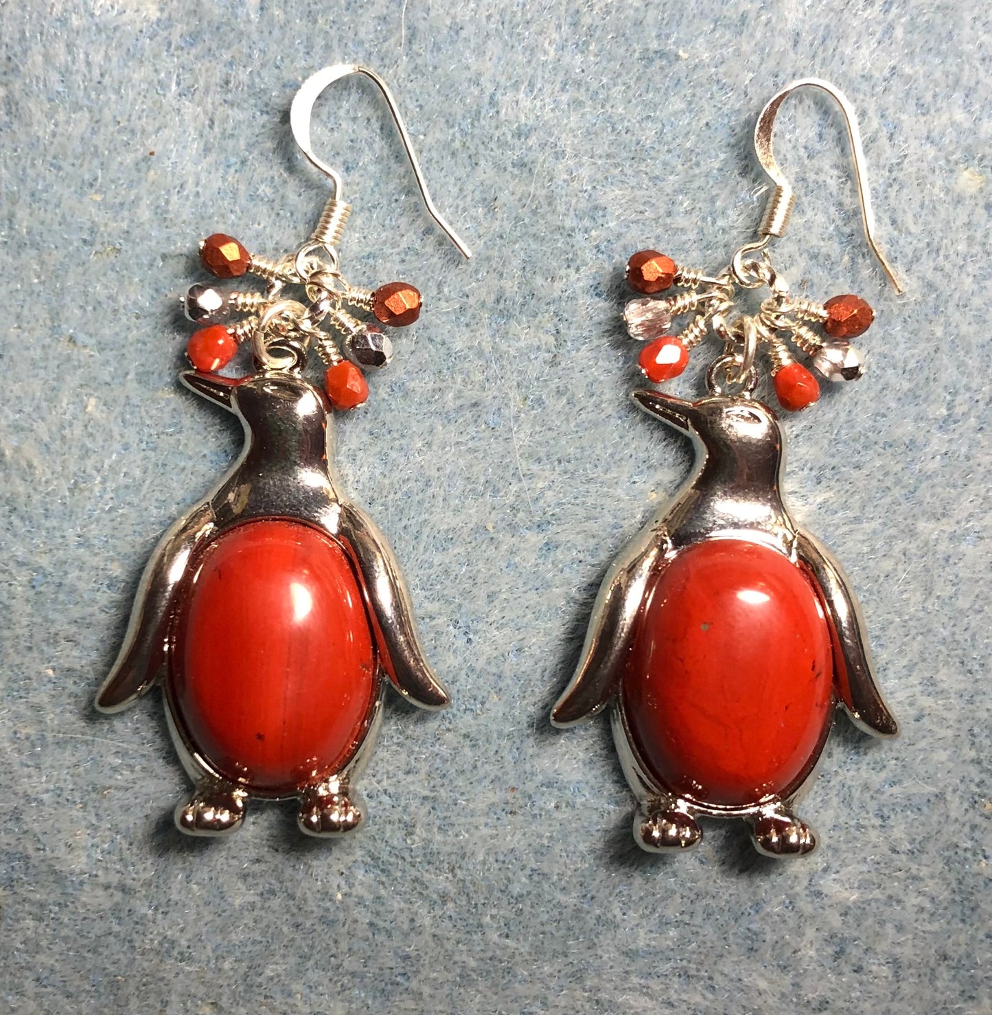 Large silver and flame jasper gemstone penguin charm earrings adorned with small dangling orange and silver Czech glass beads.