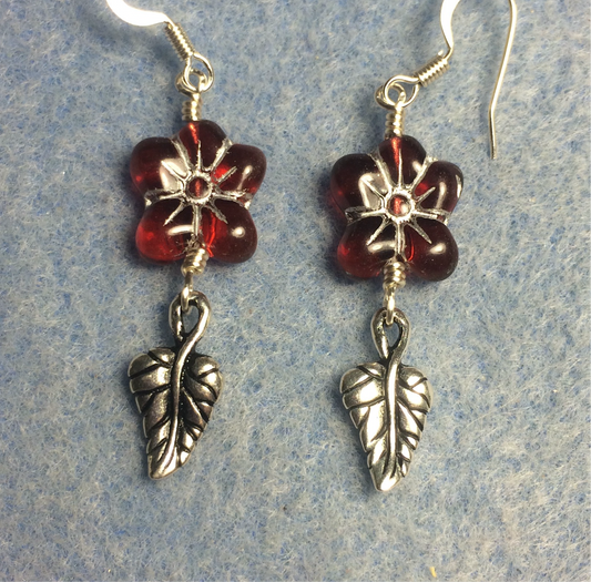 Dark red (with silver inlay) Czech glass puffy flower bead earrings adorned with silver Tierracast leaf charms.