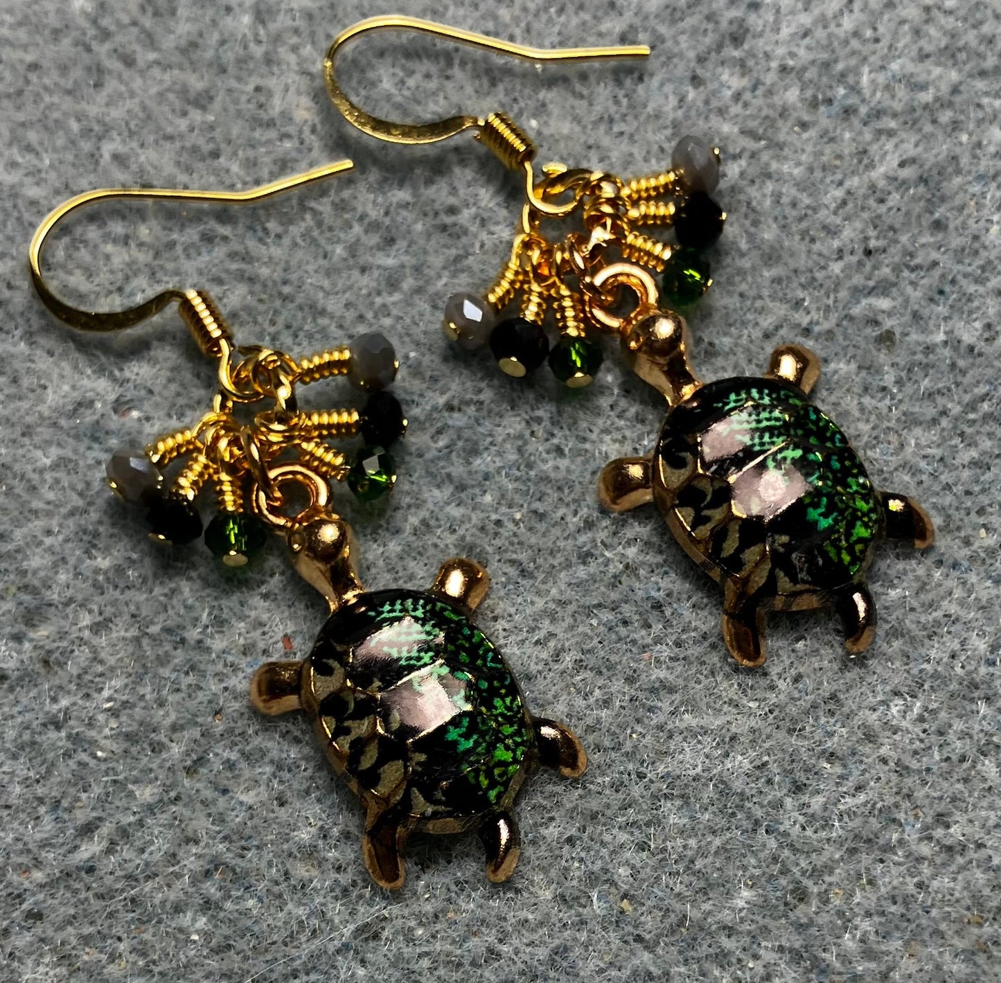 Dark green, black, and gray enamel turtle charm earrings adorned with tiny dangling dark green, black, and gray Chinese crystal beads.