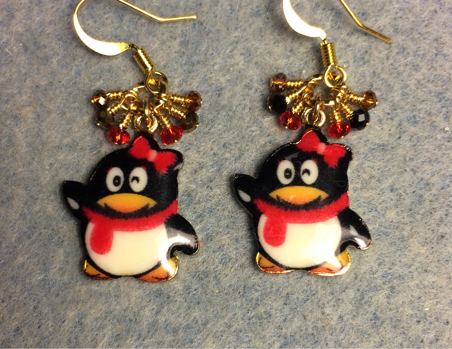 Black, red, and amber enamel penguin charm earrings adorned with tiny dangling black, red, and amber Chinese crystal beads.