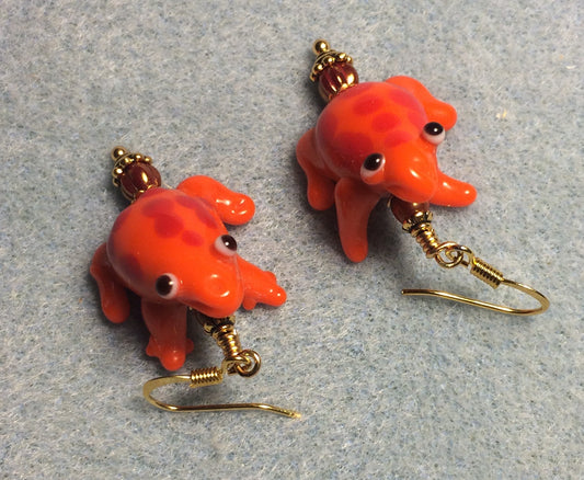 Orange lamp work spotted frog bead earrings adorned with dark orange Czech glass beads.