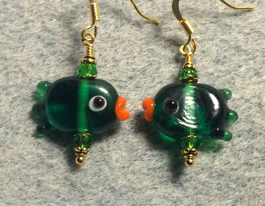 Translucent emerald green lamp work fish bead earrings adorned with emerald green Chinese crystal beads.