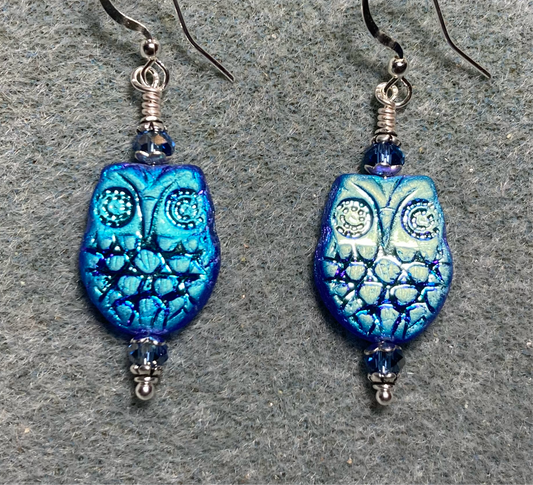 Metallic blue Czech glass owl bead earrings adorned with blue Chinese crystal beads.