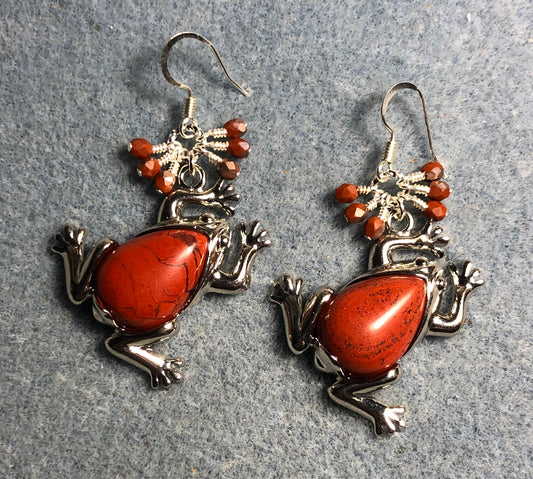 Large silver and orange flame jasper gemstone frog charm earrings adorned with small dangling orange Czech glass beads.