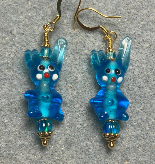 Translucent turquoise lamp work bunny rabbit bead earrings adorned with turquoise Czech glass beads.