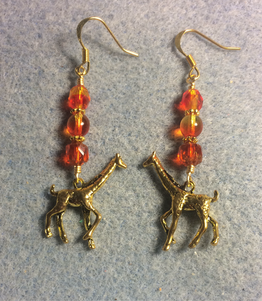 Gold giraffe charm earrings adorned with orange yellow Czech glass beads