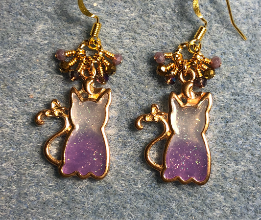 Purple and gold sparkly resin cat charm earrings adorned with small dangling purple and gold Chinese crystal beads.