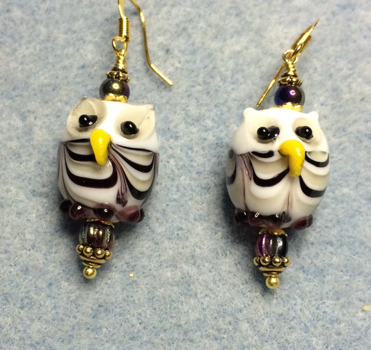 Purple and yellow lamp work owl bead earrings adorned with purple Czech glass beads.
