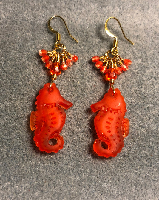 Orange sea glass seahorse pendant bead earrings adorned with orange Czech glass beads and tiny dangling orange Czech glass beads.