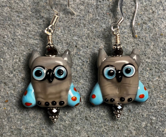 Gray and blue lamp work owl bead earrings adorned with gray Chinese crystal beads.