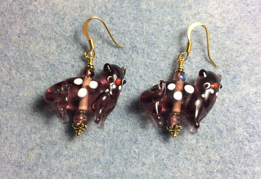 Translucent violet lamp work spotted cat bead earrings adorned with violet Czech glass beads.