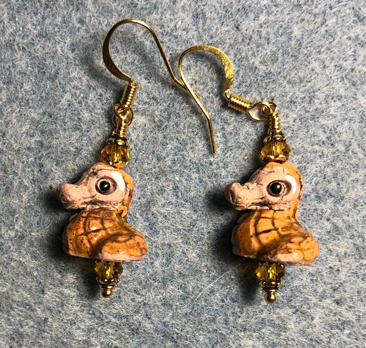 Small amber and tan ceramic seahorse bead earrings adorned with amber Chinese crystal beads.