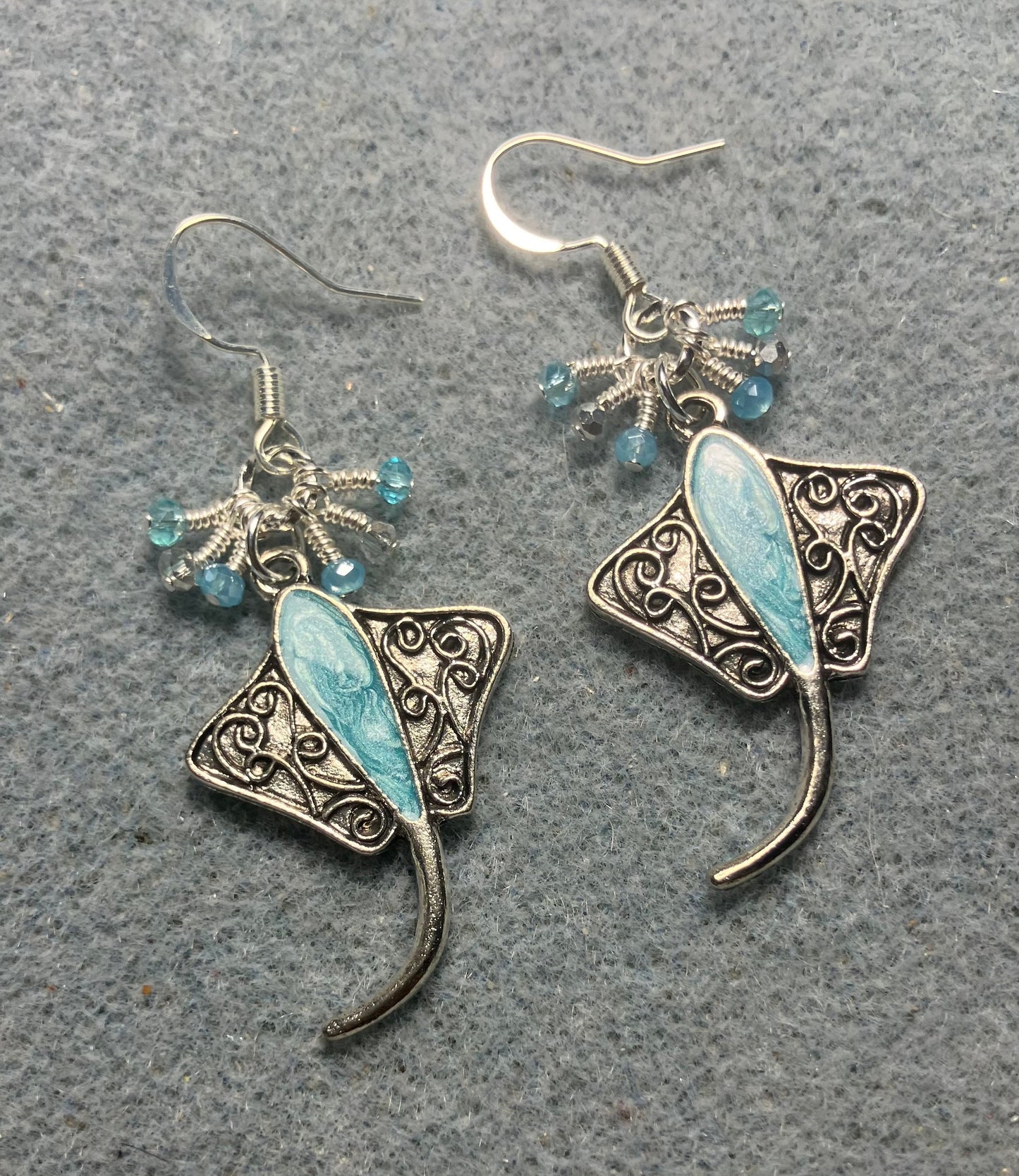 Silver and turquoise enamel stingray charm earrings adorned with tiny dangling turquoise and silver Chinese crystal beads.
