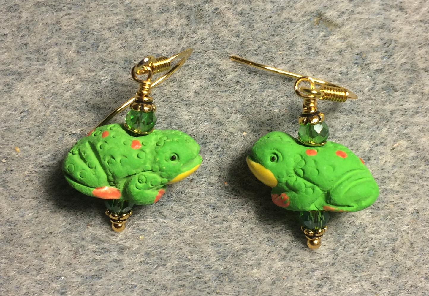 Green, yellow, and orange ceramic frog bead earrings adorned with green Chinese crystal beads.