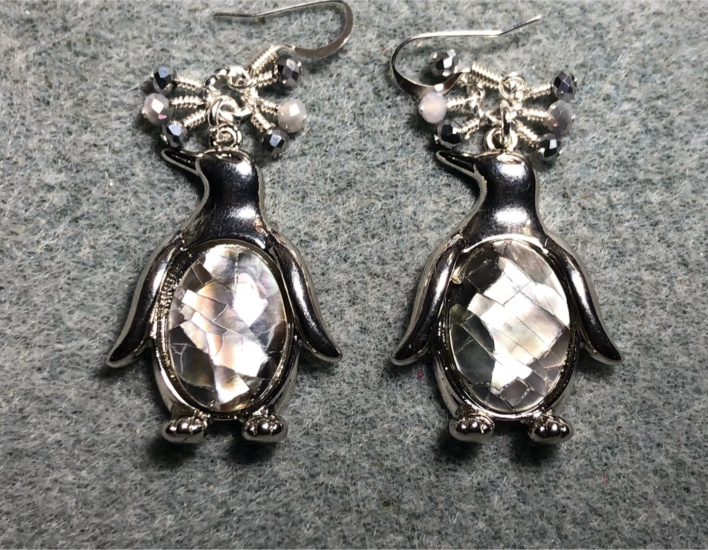 Large silver and gray abalone penguin charm earrings adorned with small dangling gray and silver Czech glass beads.