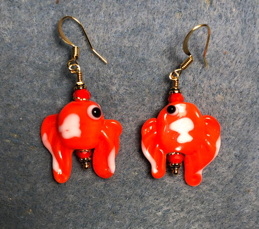 Vintage orange and white lamp work bead earrings adorned with orange Chinese crystal beads.