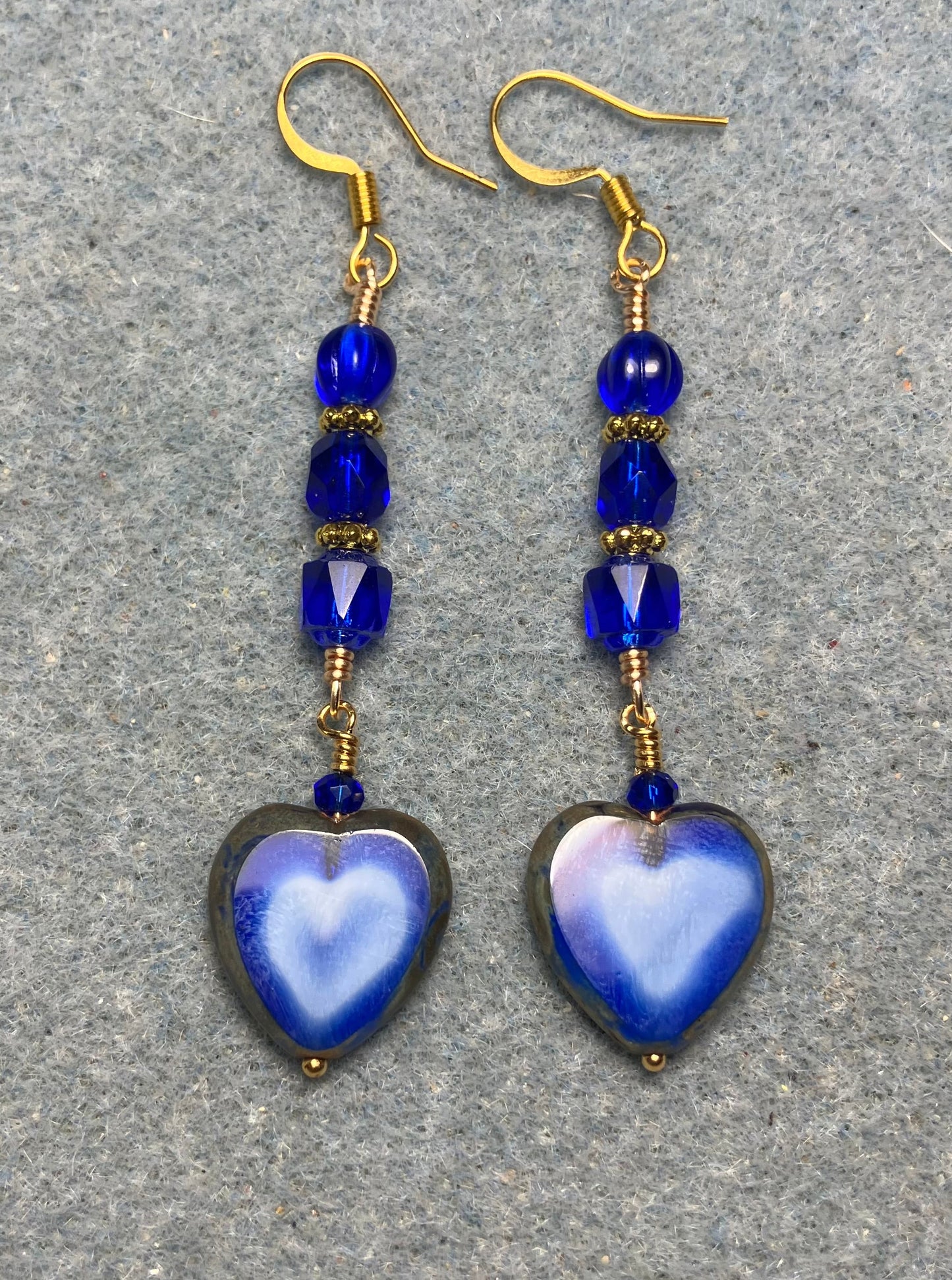 Opaque blue Czech glass heart bead earrings adorned with blue Czech glass beads.