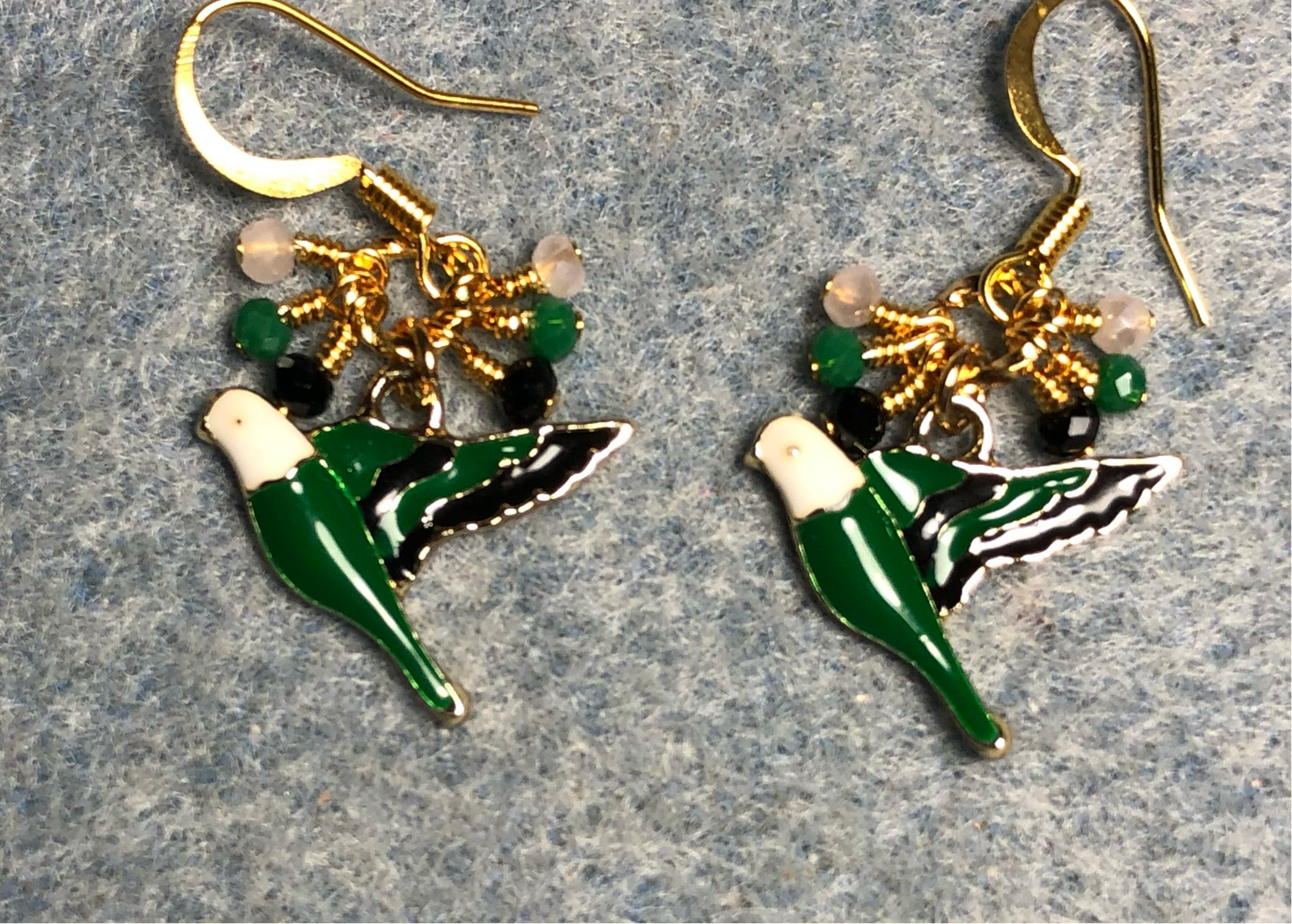 Dark green, black, and white enamel parakeet charm earrings adorned with tiny dangling dark green, black, and white Chinese crystal beads.