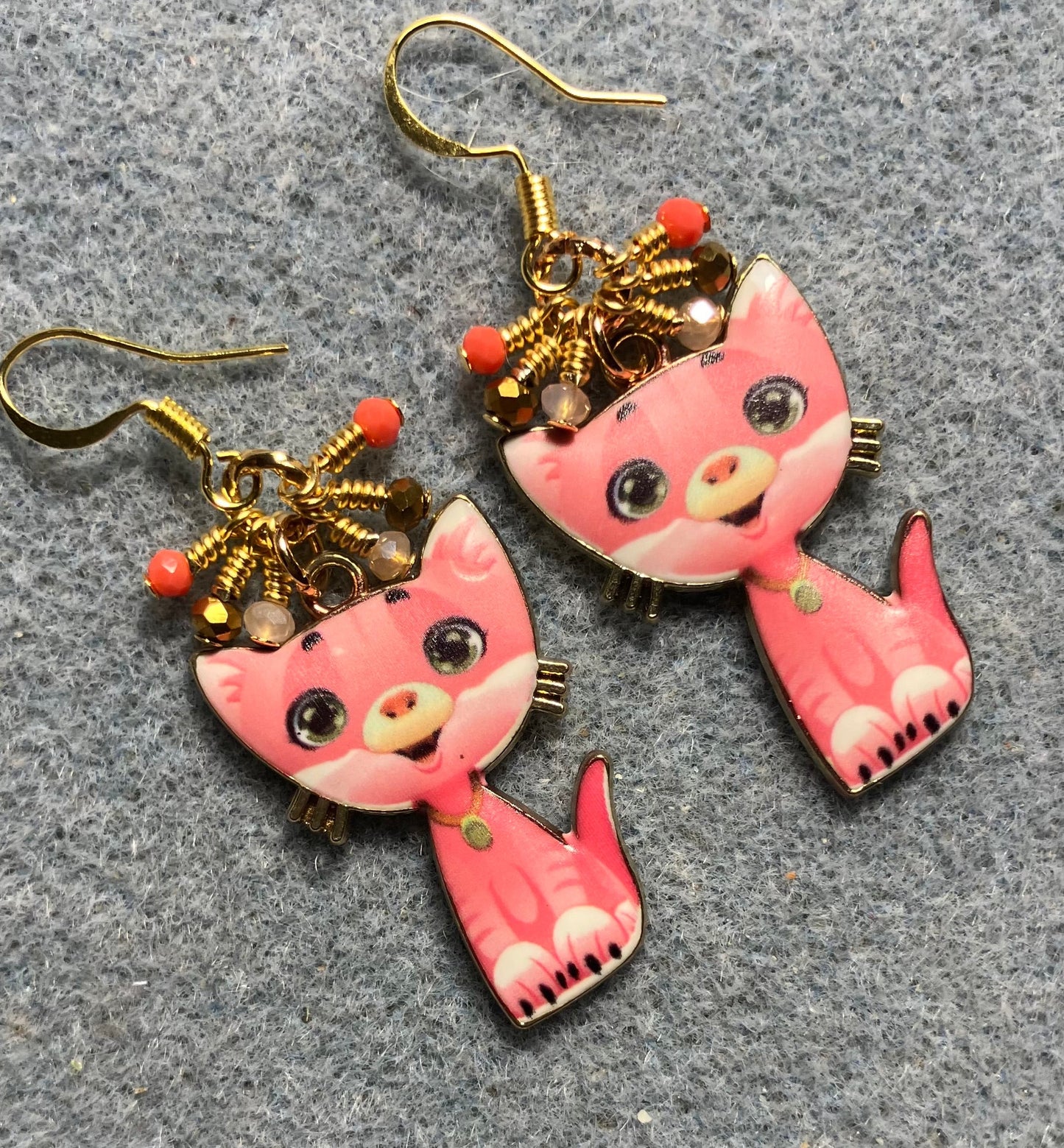 Coral and peach enamel cat charm earrings adorned with tiny dangling coral, peach, and gold Chinese crystal beads.