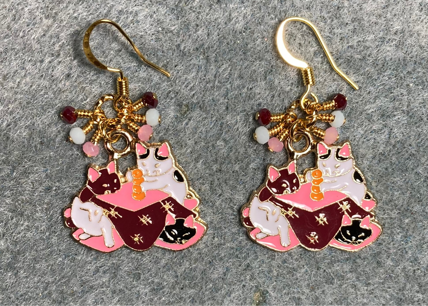 Pink, white, and dark red enamel cats charm earrings adorned with tiny dangling pink, white, and dark red Chinese crystal beads.