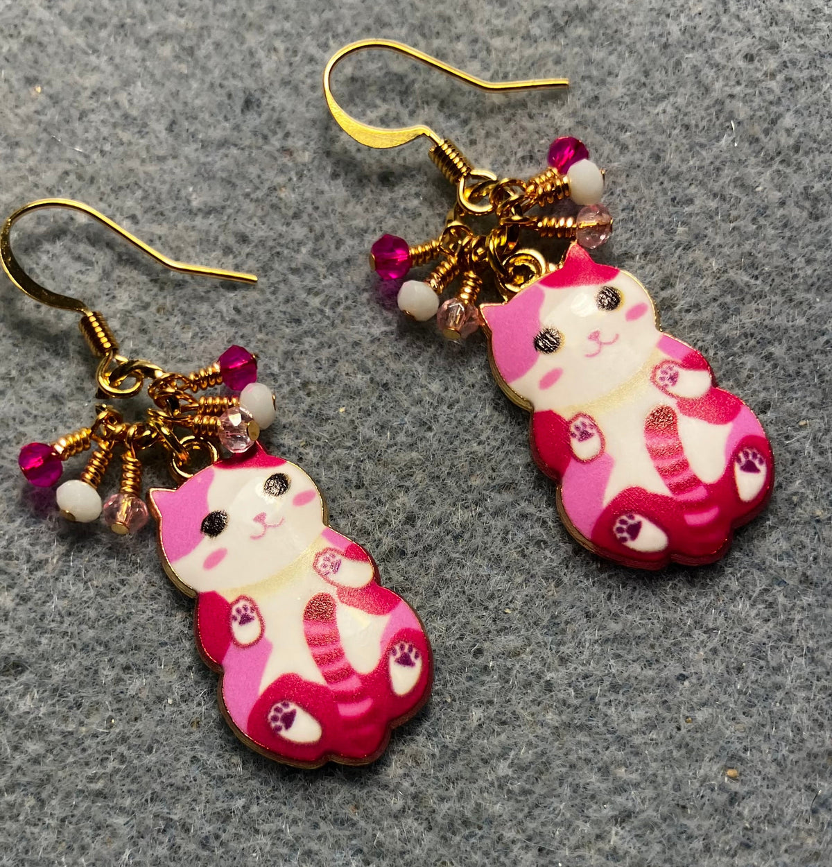 Hot pink, light pink, and white enamel cat charm earrings adorned with tiny dangling hot pink, light pink, and white Chinese crystal beads.