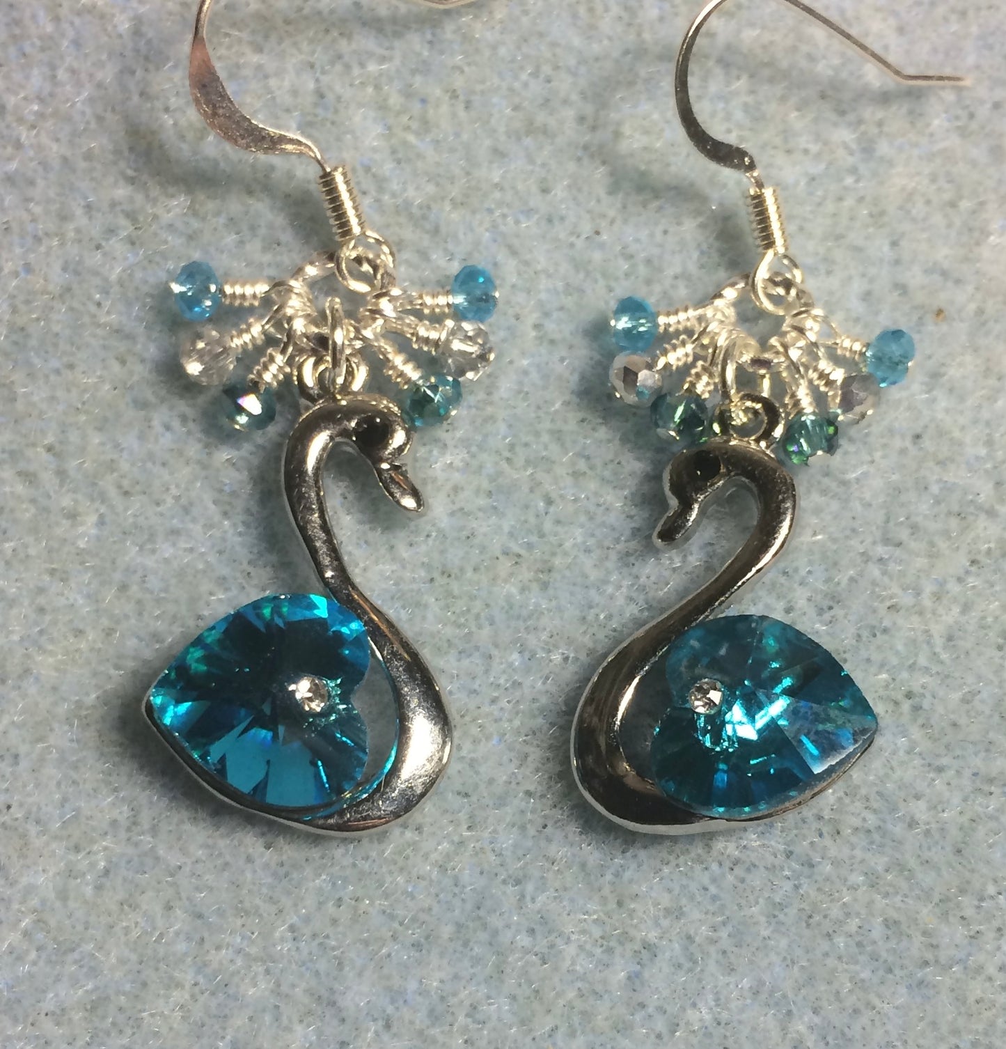 Turquoise crystal swan charm earrings adorned with tiny dangling turquoise and silver Chinese crystal beads.