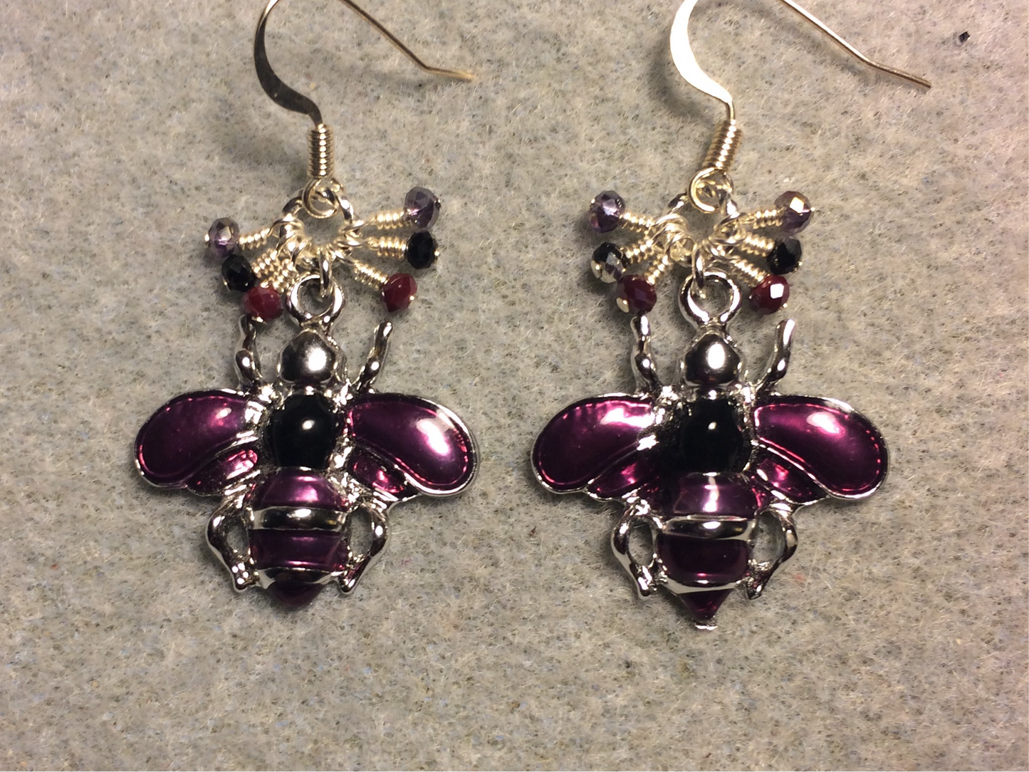 Purple and black enamel honeybee charm earrings adorned with tiny dangling purple and black Chinese crystal beads.