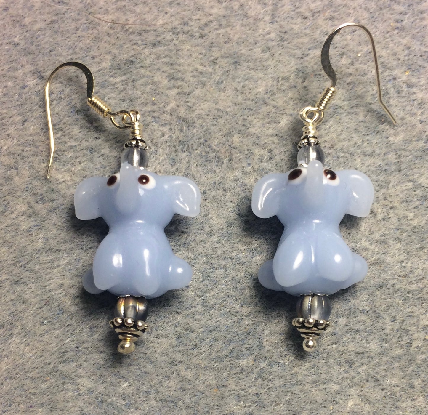 Opaque light blue lamp work sitting elephant bead earrings adorned with light blue Czech glass beads.